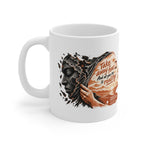 Take Away Fear white ceramic mug, handle on the left, showing a hand drawing back a cracked mask beside a face filled with a sunlit landscape.
