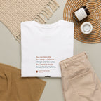 Folded white Life as a Song T-shirt styled beside beige trousers.